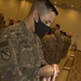 U.S. Army Sgt. 1st Class Matthew Briles, a G-6 system administrator Task Force Spartan, readies The Bronze Order of Mercury medals for their recipients