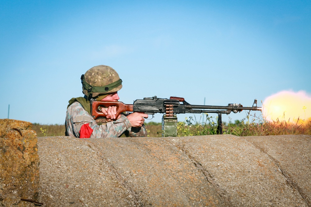 A Romanian Soldier Fires Their Weapon
