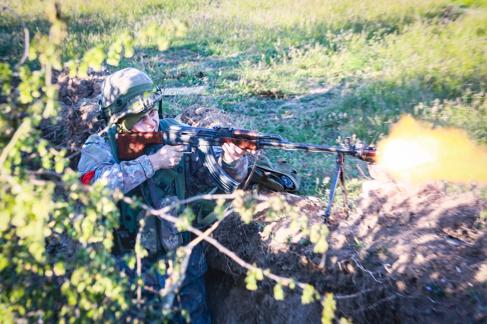 A Romanian Soldier Fires Their Weapon