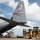 75th EAS Executes Tactical Airlift Mission in Manda Bay, Kenya A U.S. Air Force C-130 Hercules transport aircraft (tail number 83178) assigned to AMC Dyess Air Force Base is being loaded or unloaded on a flight line. Ground crew personnel and a yellow heavy forklift/loader are actively working at the rear cargo ramp of the aircraft. The Texas state flag insignia on the tail confirms the aircraft's assignment to Dyess AFB in Texas.
