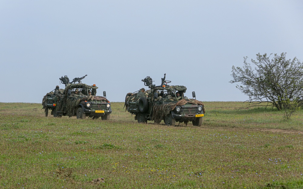 Soldiers maneuver vehicles