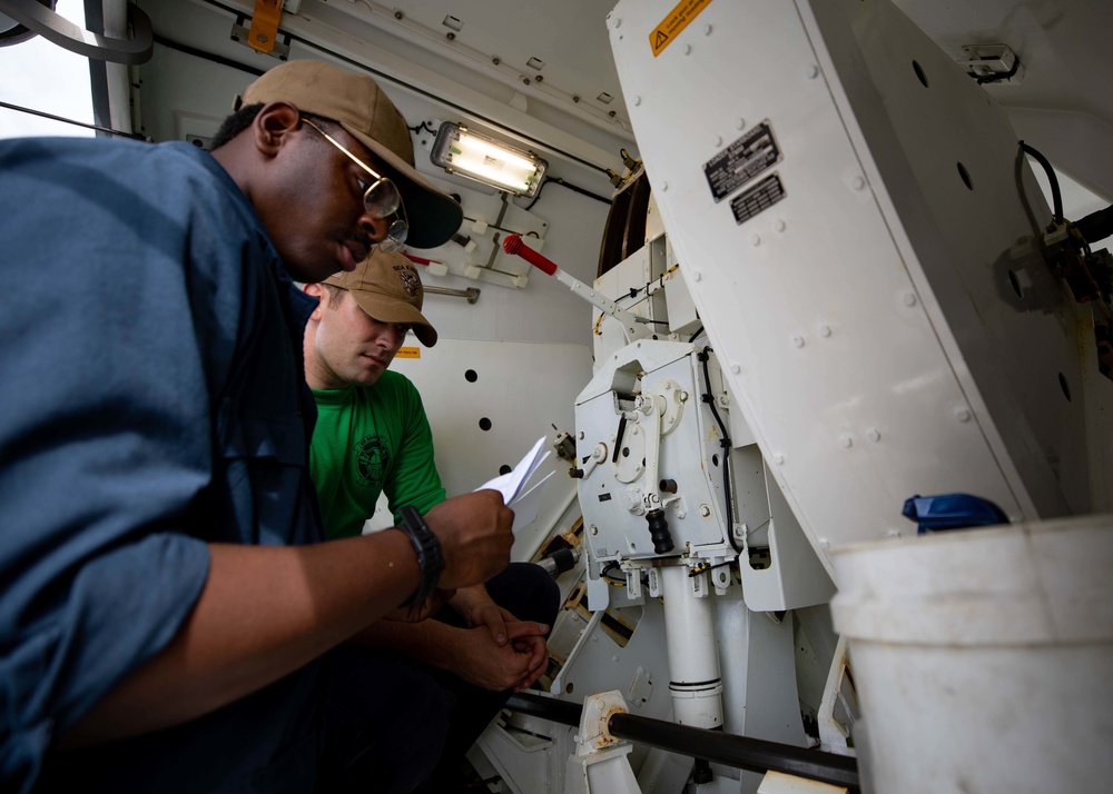 USS Sioux City and HSC 22 Sailors Conduct Maintenance on 57mm MK 110 Gun