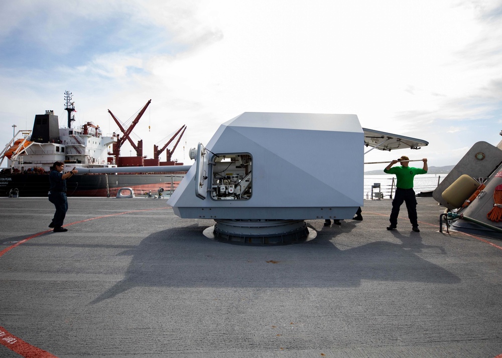 USS Sioux City and HSC 22 Sailors Conduct Maintenance on 57mm MK 110 Gun