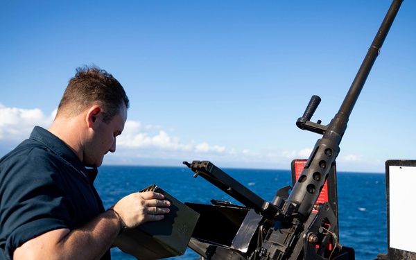USS Sioux City Sailor Stores Ammo on .50 Caliber Machine Gun