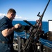 USS Sioux City Sailor Stores Ammo on .50 Caliber Machine Gun