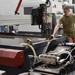 Splish, splash I was… positioning a metal block on the water jet cutting table