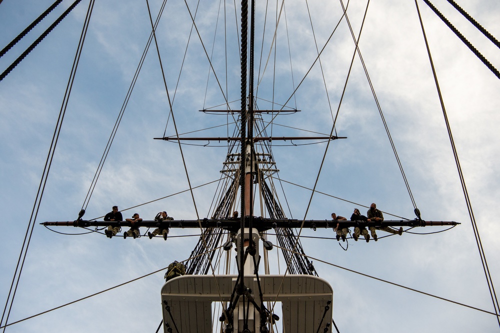 USS Constitution Sailors climb the mizzen top yard