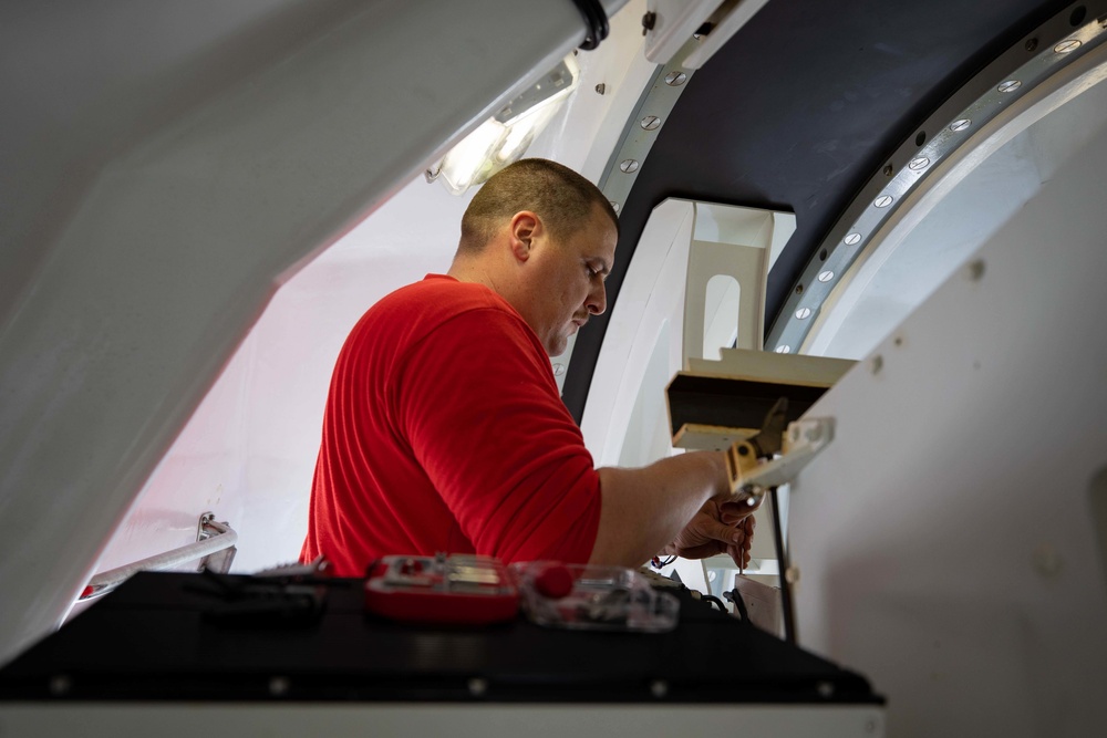 USS Sioux City Sailor Conducts Maintenance on 57mm MK 110 Gun