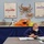 A U.S. Coast Guard member wearing a face mask and blue uniform sits at a table reviewing documents in a binder. The setting appears to be a fisheries or maritime training/education room decorated with mounted fish specimens, crab mounts, and informational diagrams about fishing vessels and species. The wall displays include charts labeled 'Catcher Vessel Pot Gear 107 Pacific Cod' and 'Catcher Processor Pelagic Trawl 270 AFA Vessel Pollock.'