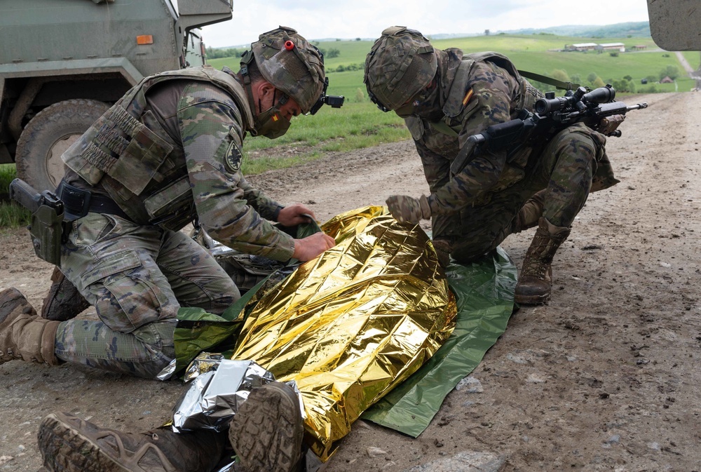 Spanish Soldiers assigned to the VII Brigade BRILAT treat a simulated casualty during Exercise Steadfast Defender 2021 in Romania. More than 270 Spanish troops deployed to Romania in support of the exercise