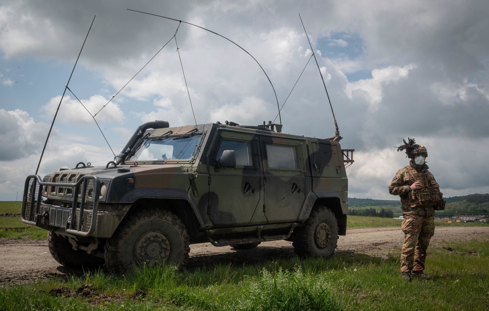 An Italian Soldier assigned to the 1st Mechanized Battalion ‘Bersaglieri’ stands beside an Iveco light multirole vehicle while conducting reconnaissance training during Exercise Steadfast Defender 2021 in Romania