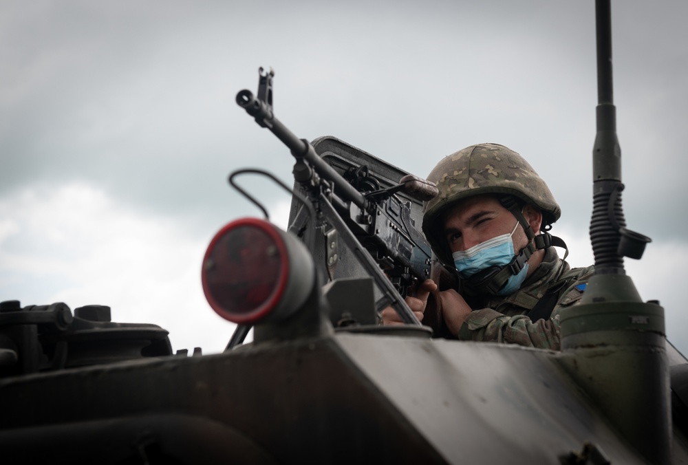 A Romanian Soldier mans a gun mount while conducting reconnaissance training during Exercise Steadfast Defender 2021 in Romania