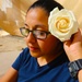 A Mother from 36th Infantry Division, Task Force Spartan, places a flower in her hair at Mother's Day celebration