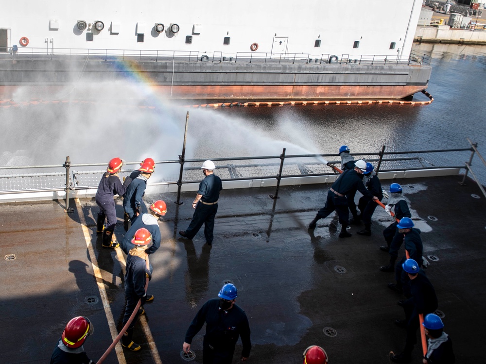 Sailors Discharge Participate in Fire Drill