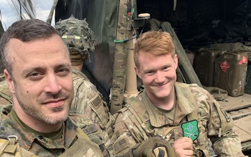 International Relations: German Officer and U.S. Soldier Exchange Patches at the Gun Line