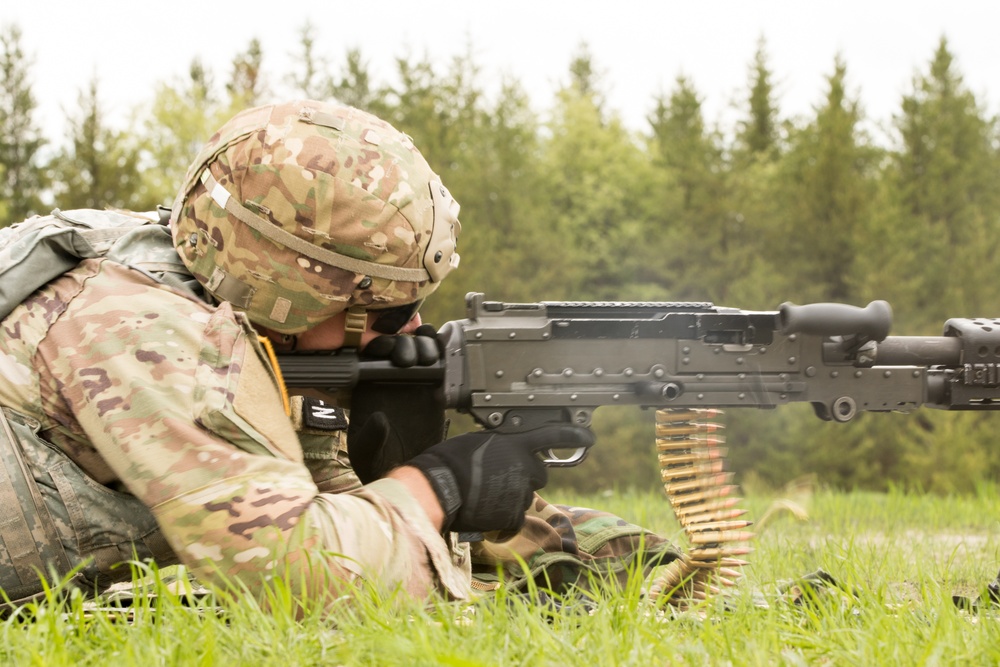 Soldier firing a M240