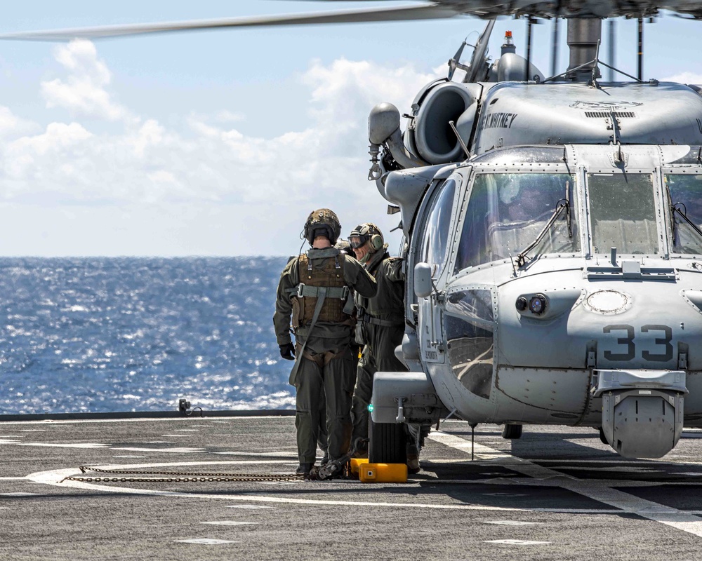 Vice Adm. Andrew Lewis, commander, Joint Force Command Norfolk (JFCNF), and commander, U.S. Second Fleet, disembarks an MH-60 Sea Hawk helicopter