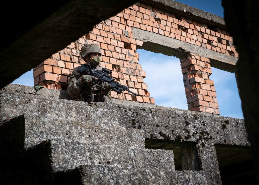 A Spanish Soldier assigned to the BRILAT Brigade holds his position while conducting urban combat training during Exercise Steadfast Defender 2021