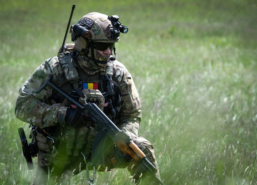 A Romanian special forces troop holds his position while training during Exercise Steadfast Defender 2021