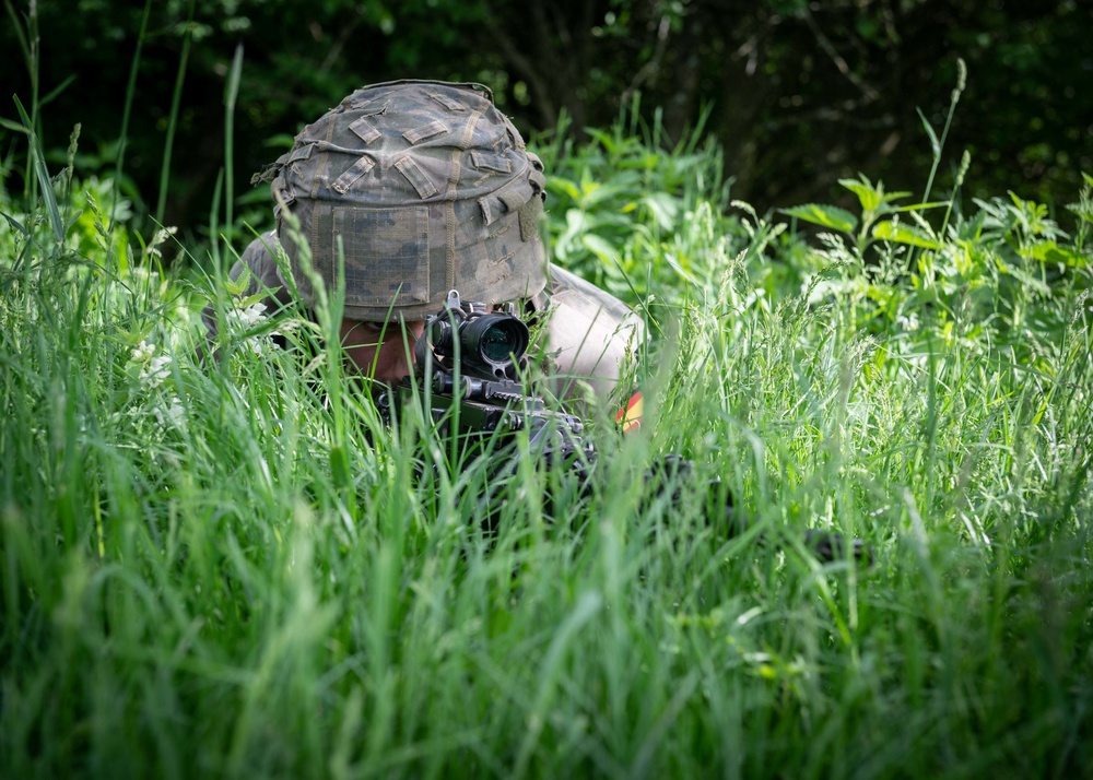 A Spanish Soldier assigned to the BRILAT Brigade holds his position while conducting urban combat training during Exercise Steadfast Defender 2021