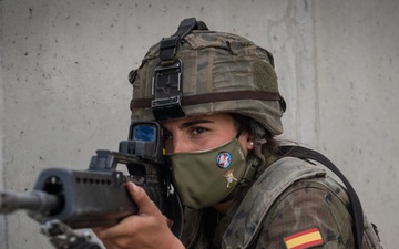 A Spanish Soldier assigned to the BRILAT Brigade aims her HK G36 rifle while holding her position conducting urban combat training during Exercise Steadfast Defender 2021