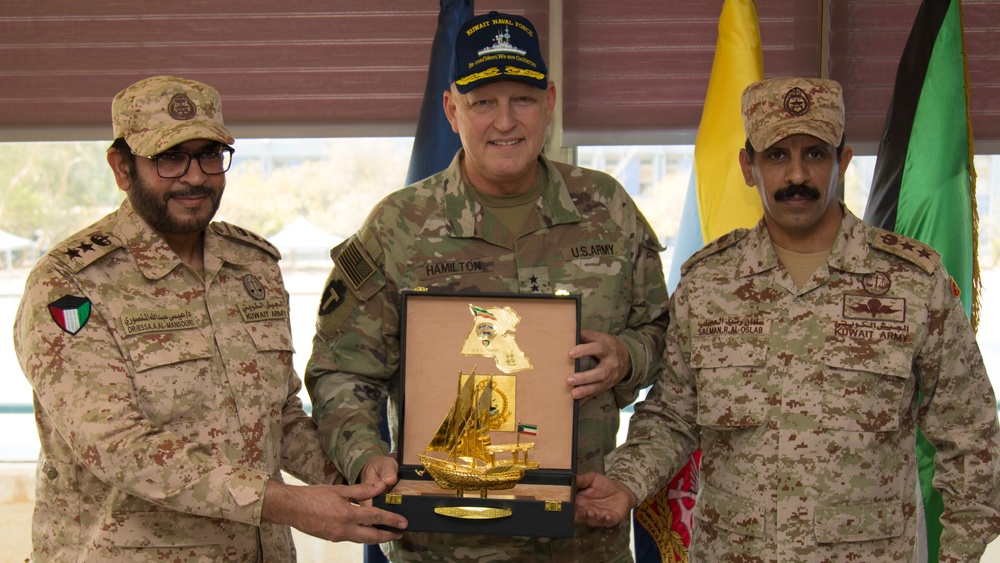 Task Force Spartan Commanding General and Kuwait Army Legal Officers exchange gifts after legal symposium