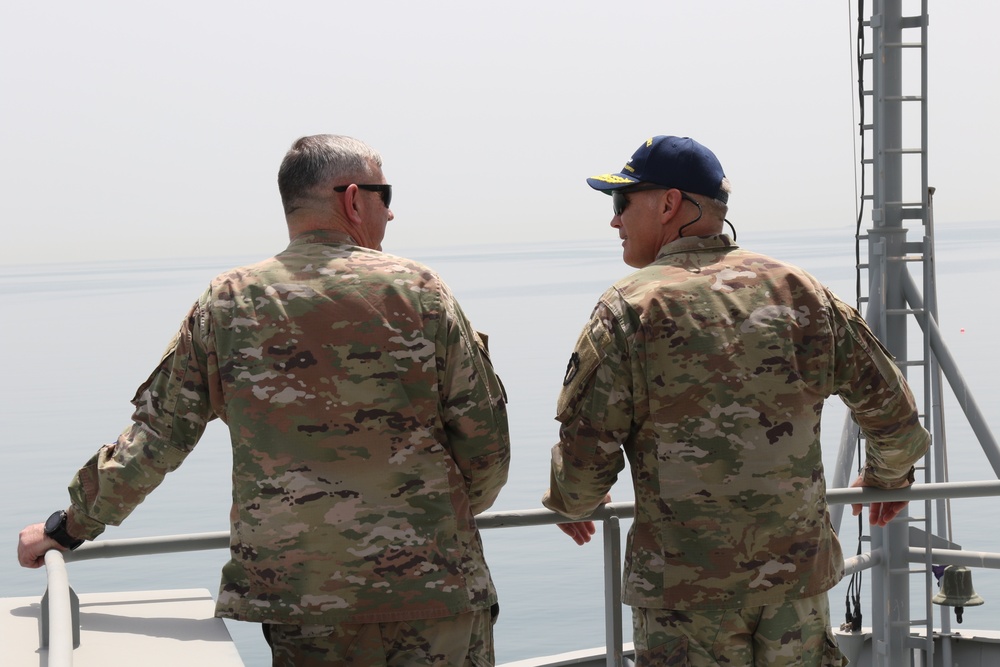 Task Force Spartan Deputy Commanding Genera - Operations, Brig. Gen. Win Burkett, jokes with Lt. Col. Wesley West while riding Kuwait Naval vessel