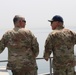 Task Force Spartan Deputy Commanding Genera - Operations, Brig. Gen. Win Burkett, jokes with Lt. Col. Wesley West while riding Kuwait Naval vessel