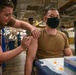 administers the COVID-19 vaccine