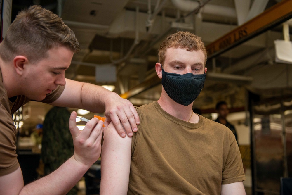 administers the COVID-19 vaccine