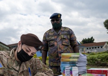 USAF Combat Aviation Advisors present school supplies to Moi Air Base students