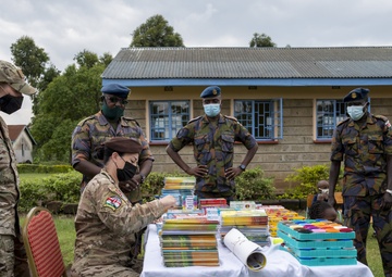 USAF Combat Aviation Advisors present school supplies to Moi Air Base students