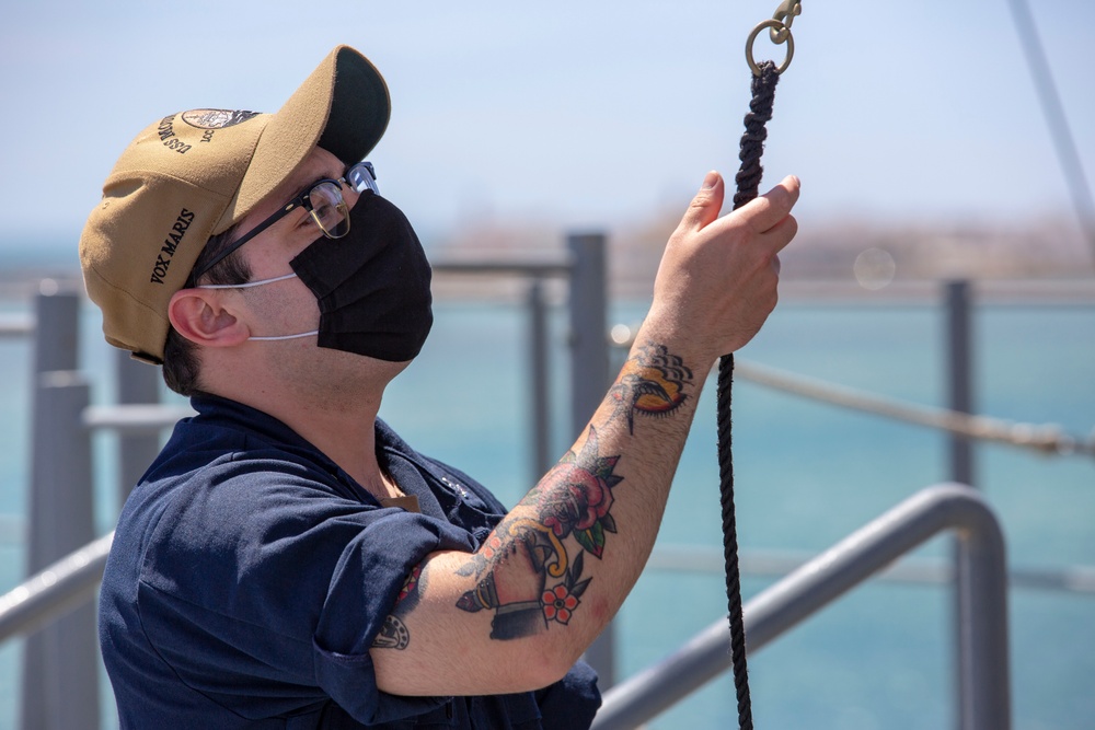 Operations Specialist 3rd Class Hector Imperial shifts colors as the Blue Ridge-class command and control ship USS Mount Whitney (LCC 20) gets underway from Rota, Spain during Exercise Steadfast Defender 2021