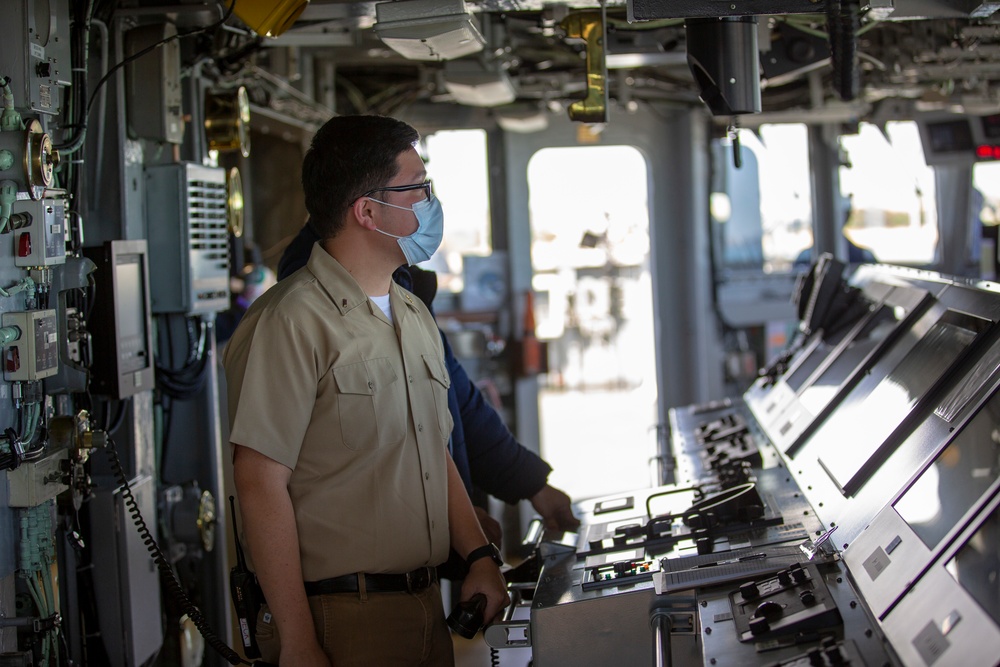 A Military Sealift Command civil service mariner stands bridge watch aboard the Blue Ridge-class command and control ship USS Mount Whitney as the ship gets underway from Rota, Spain during Steadfast Defender 2021