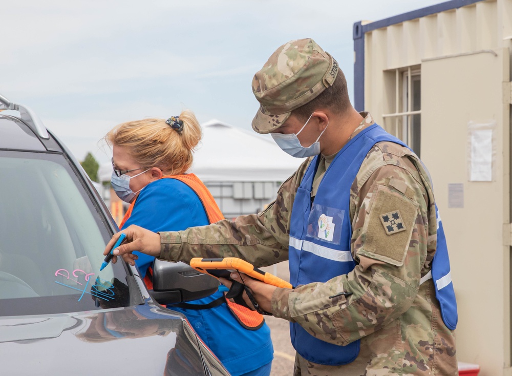 2nd Stryker Brigade Combat Team, 4th Infantry Division Soldiers work side-by-side with civilian nurses to vaccinate the Pueblo community