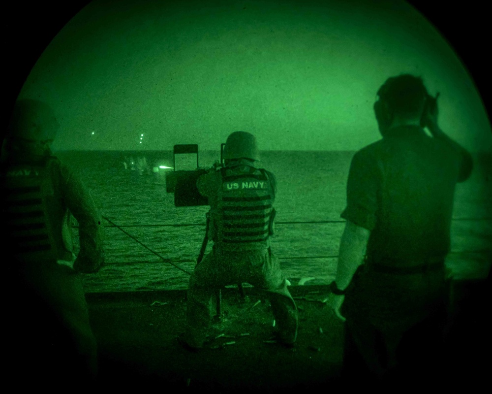 A Sailor fires a .50 Cal. Machine Gun on a target during a live fire exercise