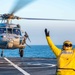 A Military Sealift Command civil service mariner launches an MH-60 Sea Hawk helicopter