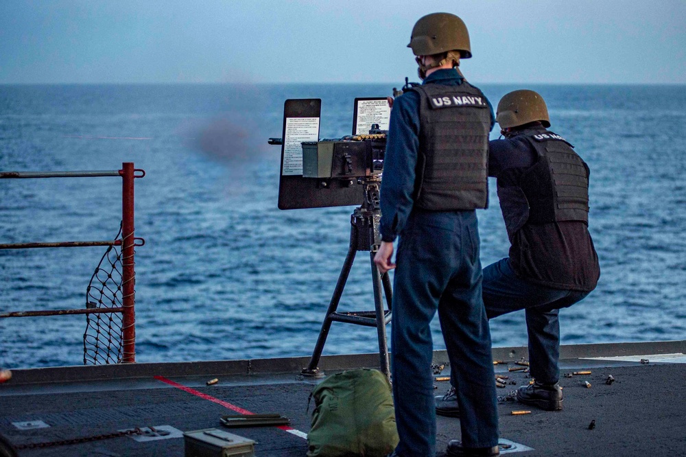 A Sailor fires a .50 Cal. Machine Gun on a target during a live fire exercise