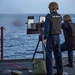 A Sailor fires a .50 Cal. Machine Gun on a target during a live fire exercise