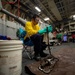 USS Sioux City Sailor Performs Maintenance on Tie-Down Chains