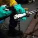 USS Sioux City Sailor Performs Maintenance on Tie-Down Chains