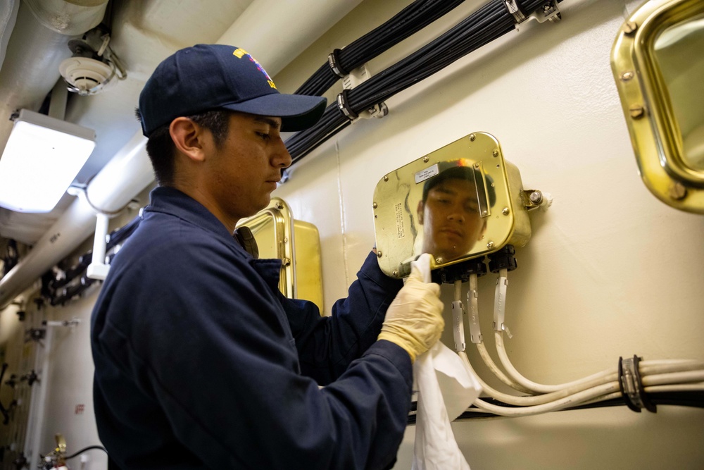 USS Sioux City Sailor Polishes Brass During Cleaning Stations