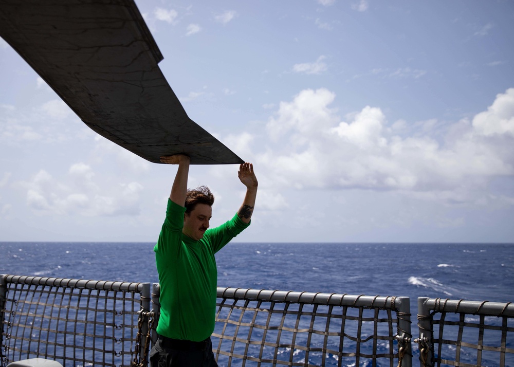 HSC 22 Sailor Unfolds a Rotor Blade of an MH-60S Sea Hawk Helicopter