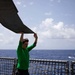 HSC 22 Sailor Unfolds a Rotor Blade of an MH-60S Sea Hawk Helicopter