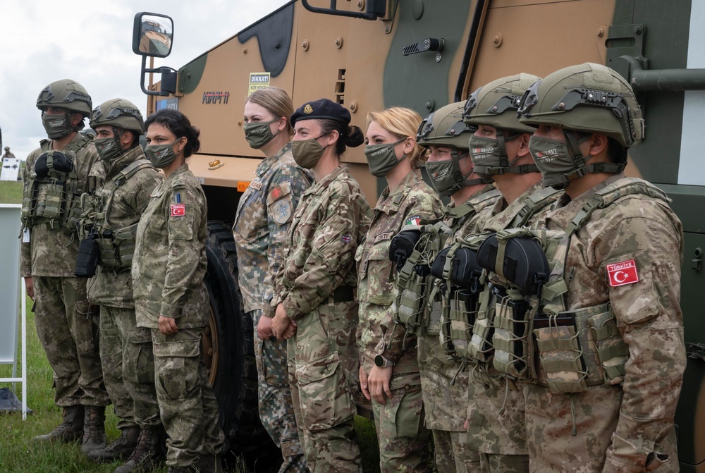 Turkish, Latvian, British and Italian medical personnel pose for a photo at a static display of equipment during NATO Exercise Steadfast Defender 2021