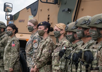 Turkish, Latvian, British and Italian medical personnel pose for a photo at a static display of equipment during NATO Exercise Steadfast Defender 2021