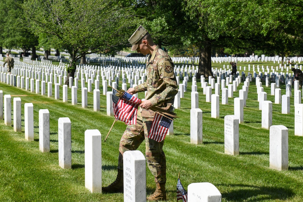 Service members place flags at Arlington National Cemetery