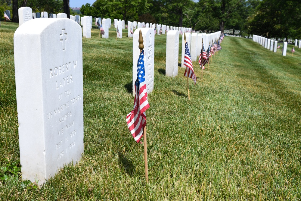 Service members place flags at Arlington National Cemetery