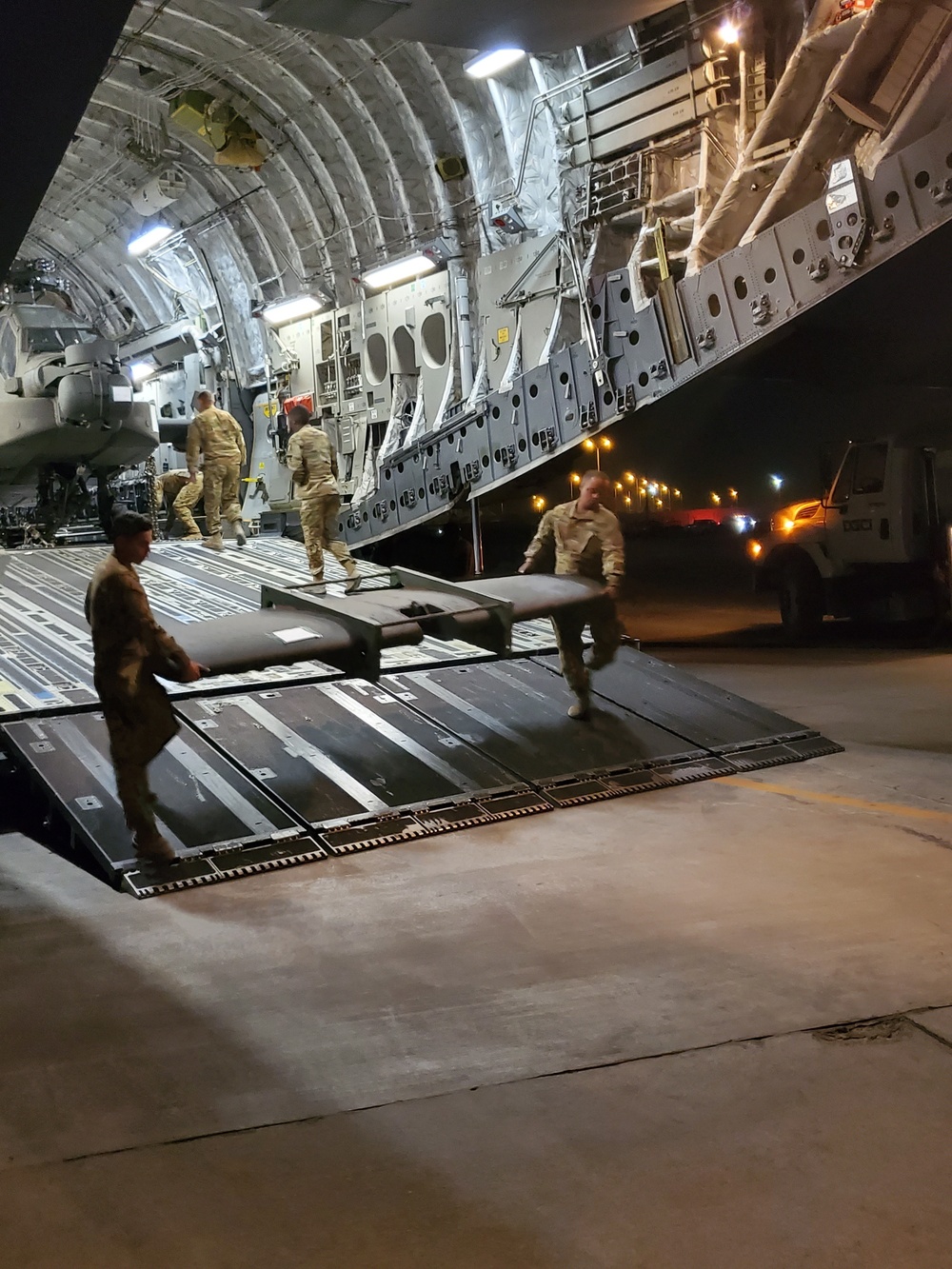 Task Force Wolfpack offloads an AH-64 Apache from a U.S. Air Force C-17 Globemaster
