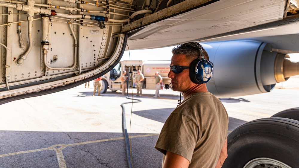 332d AEW assigned KC-135s, forward deployed in CENTCOM, accomplish hot pit refuel